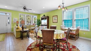 A dining area with a round table, chairs, and a patterned rug. - Walk to Beach Surfside Beach Home w/ Private Pool & Linens (Surfside Beach)