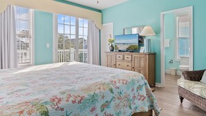 A bedroom with a large bed, a dresser, a television, and a window with curtains. - Walk to Beach Surfside Beach Home w/ Private Pool & Linens (Surfside Beach)