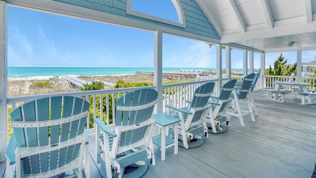 A covered outdoor area with Adirondack chairs and a view of the ocean. - 7-Bedroom Home w/ Private Pool & Beach Access (Garden City Beach)