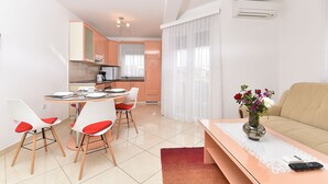 A compact living space with a dining area, kitchenette, and a sofa. - Apartment 396/904 (Istria - Medulin), 300m from the beach (Medulin)