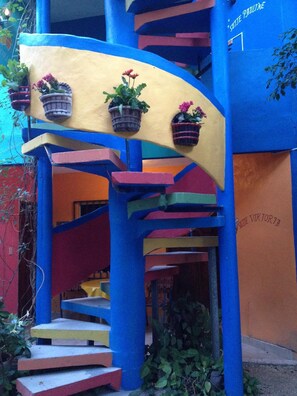 A colorful staircase with potted plants on the handrail, leading to a lower level. - Hotel Colorado Playa Del Carmen (Playa del Carmen)