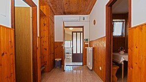 A hallway with wooden walls and a tiled floor, leading to a room with a toilet and a sink. - Apartment 531/1273 (Istria - Stinjan), 700m from the beach (Stinjan)