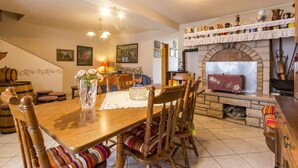 A cozy dining area with a wooden table, chairs, and a vase of flowers. - House 561/1347 (Istria - Rakalj), 2500m from the beach (Rakalj)