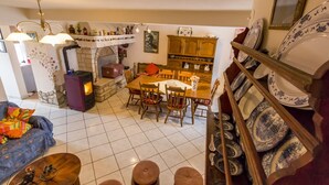 A cozy living room with a fireplace, a dining area, and a collection of blue and white plates on a rack. - House 561/1347 (Istria - Rakalj), 2500m from the beach (Rakalj)
