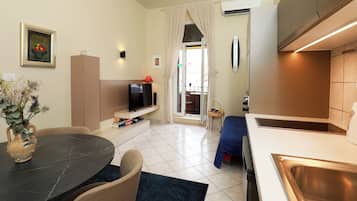 City Apartment, 1 Bedroom, Balcony | Living area | 82-cm flat-screen TV with cable channels, TV