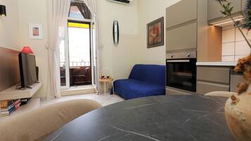 City Apartment, 1 Bedroom, Balcony | Living area | 82-cm flat-screen TV with cable channels, TV