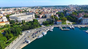 Explore the historic city from a unique perspective, with a prominent landmark and bustling marina.