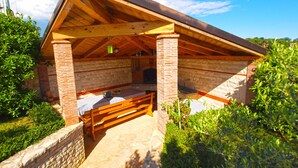 A rustic wooden structure with a pitched roof, brick walls, and a stone foundation. - Apartment 624/1489 (Istria - Pula), 2500m from the beach (Pula)