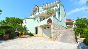 A two-story building with a light blue facade, a brick entrance, and a small balcony. - Apartment 624/1489 (Istria - Pula), 2500m from the beach (Pula)