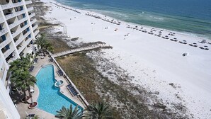 A hotel with a pool, beach, and ocean view. - Luxury Beachfront 4BR/4BA Condo Sleeps 13 with Stunning Views and Large Balcony (Orange Beach)