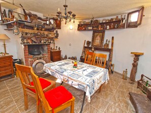 A traditional room with a fireplace, wooden furniture, and various decorative items.