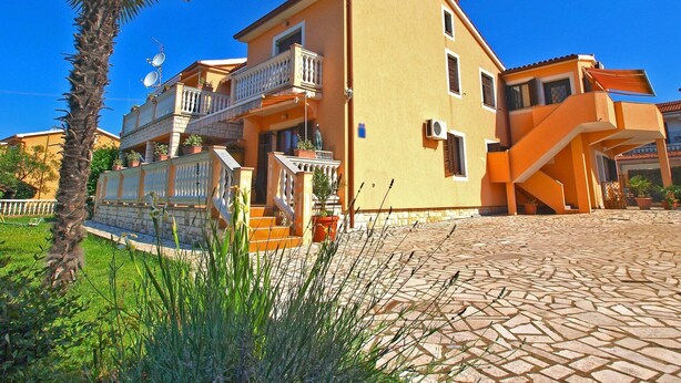 A two-story building with a balcony, a staircase, and a paved courtyard. - Apartment 768/1789 (Istria - Fažana), 500m from the beach (Fažana)