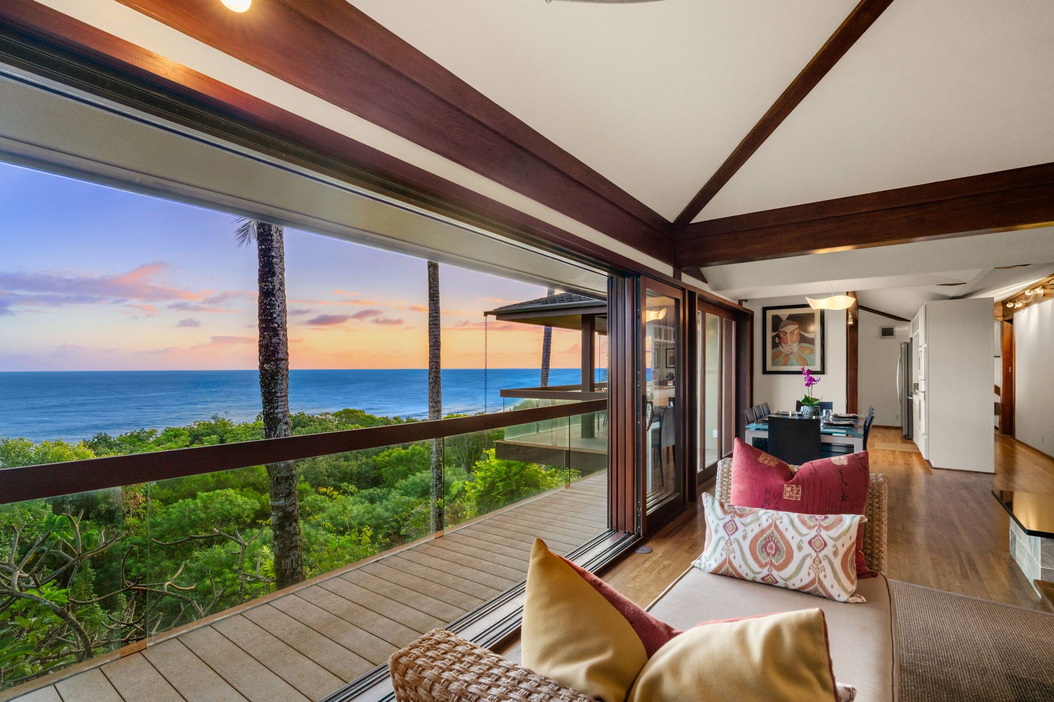 A modern room with a large window overlooking a scenic view of the ocean and greenery.
