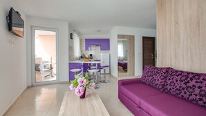 A modern apartment with a kitchen, dining area, and living room. - Apartment 813/1902 (Istria - Medulin), 90m from the beach (Medulin)