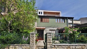 A two-story house with a stone wall entrance, a small porch, and a car parked in front. - Apartment 826/1935 (Istria - Pula), 75m from the beach (Pula)