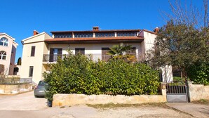 A two-story building with a balcony, a car parked in front, and a gate. - Apartment 914/2123 (Istria - Medulin), 700m from the beach (Medulin)