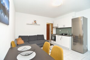 Enjoy a compact, modern space with a sofa, dining table, and kitchenette.