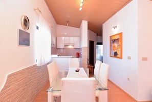 Enjoy a contemporary dining experience in this stylish space with a glass-top table and modern appliances.