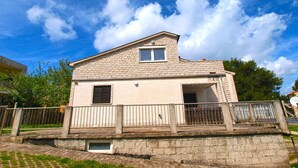 A two-story house with a brick facade, a small balcony, and a window with shutters. - Apartment 964/2472 (Istria - Premantura), 450m from the beach (Premantura)