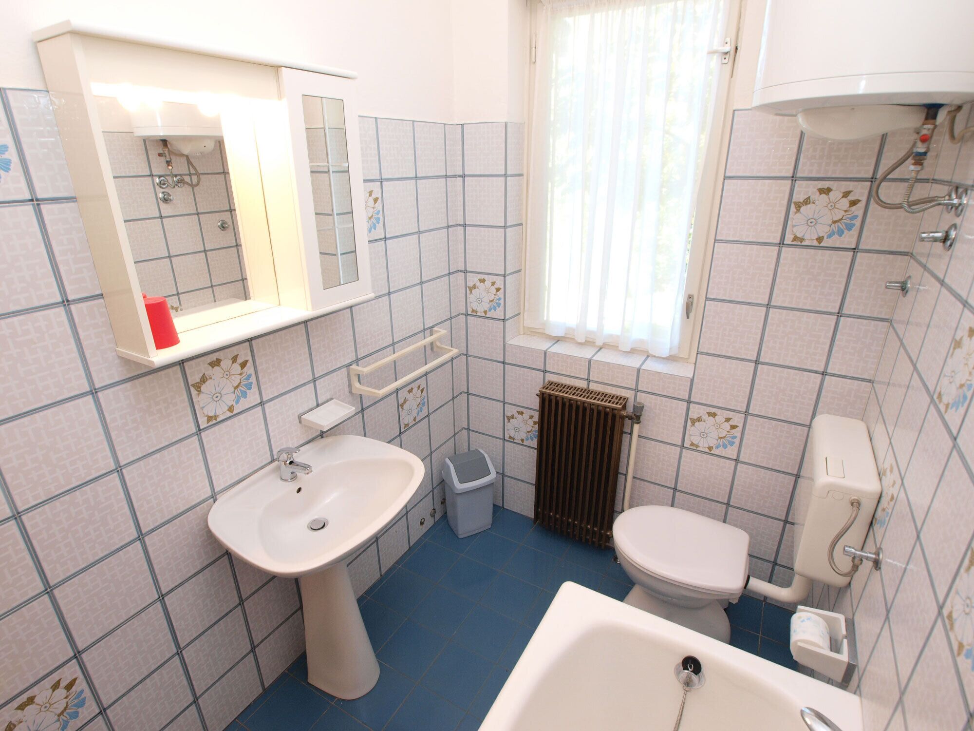 A bathroom with a sink, toilet, and bathtub.