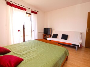 A bedroom with a bed, a television, and a window with curtains. - Apartment 994/3135 (Istria - Fažana), 350m from the beach (Fažana)