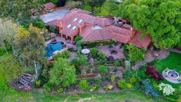 A large house with a swimming pool, surrounded by lush greenery and a well-maintained garden. - RedSmith Ranch (San Joaquin County)