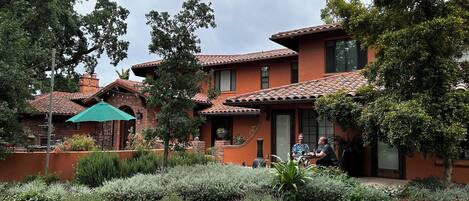 A two-story house with a brick exterior and a tiled roof.