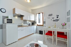 Enjoy cooking in this well-equipped kitchen with a gas stove, microwave, and coffee machine.