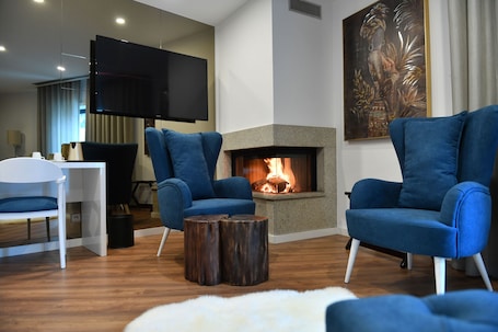 Superior Suite, Fireplace, Garden View | Living area | 55-inch flat-screen TV with cable channels, TV