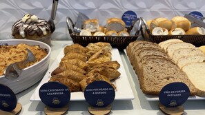 A buffet with various food items including mini croissants, mini folded cheese, and whole grain bread. - Pousada Amanhecer do Sul (Penha)