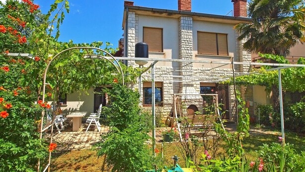 A two-story stone house with a garden in front, a wooden deck, and a brick chimney. - Apartment 1142/9868 (Istria - Valbandon), 750m from the beach (Valbandon)