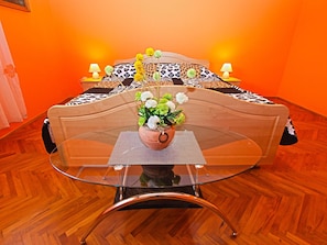 Relax in this stylish room with a glass-top table, leopard print bedding, and a comfortable bed.