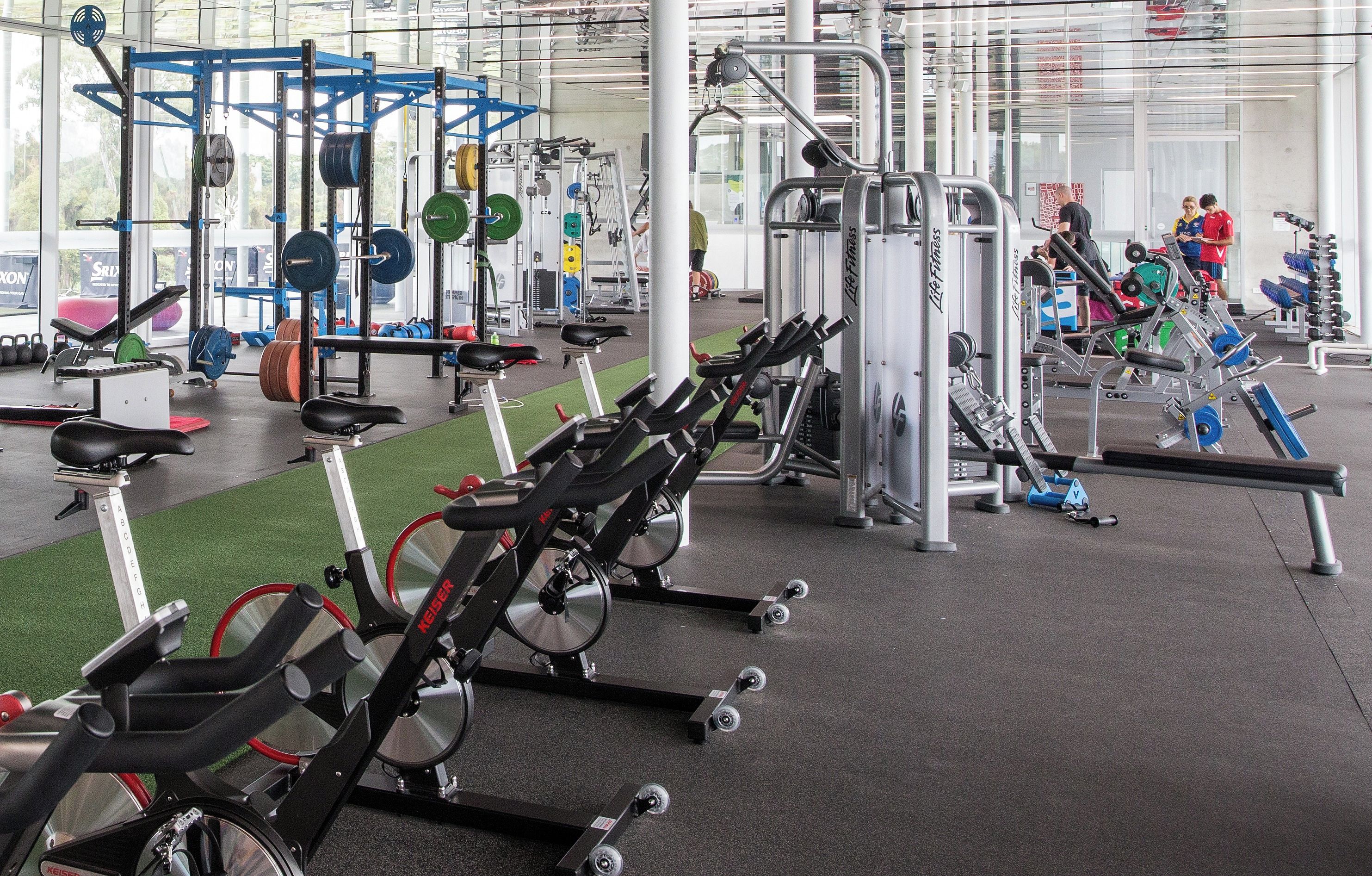 A gym with exercise equipment, located at KDV Sport.