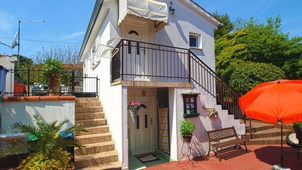 A two-story building with a balcony, a small garden, and outdoor seating. - Apartment 1227/11310 (Istria - Premantura), 300m from the beach (Premantura)