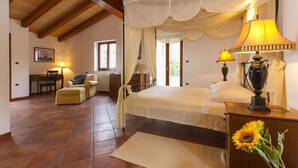 A bedroom with a canopy bed, two bedside lamps, a small table with a lamp, a chair, a desk, and a window with curtains. - Apartment 1255/12014 (Istria - Koromačno), 4000m from the beach (Koromačno)