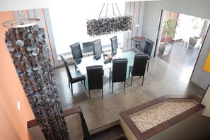 Enjoy meals in this stylish dining area with a glass-top table and comfortable seating.
