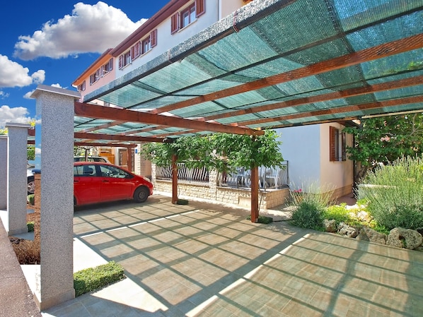 Guests can park their vehicles in this secure, covered area surrounded by lush greenery.