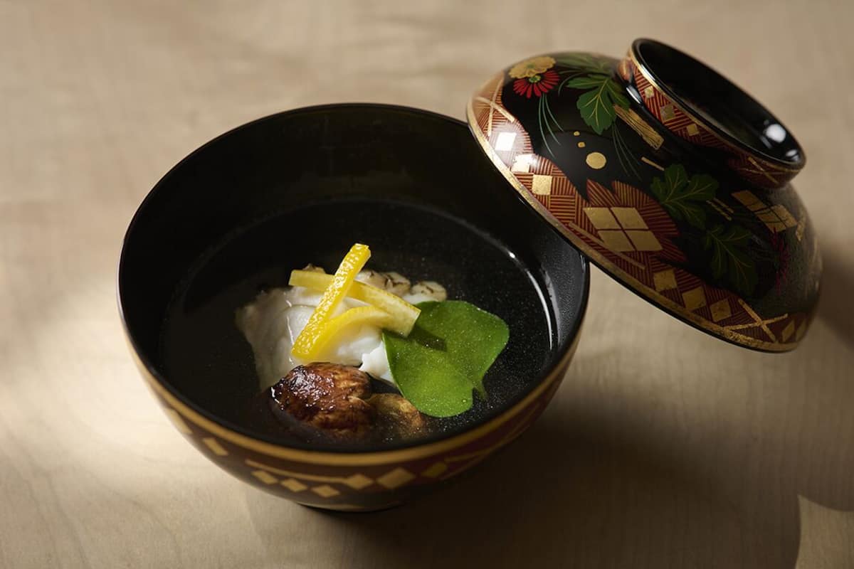 A bowl of food with a decorative lid.