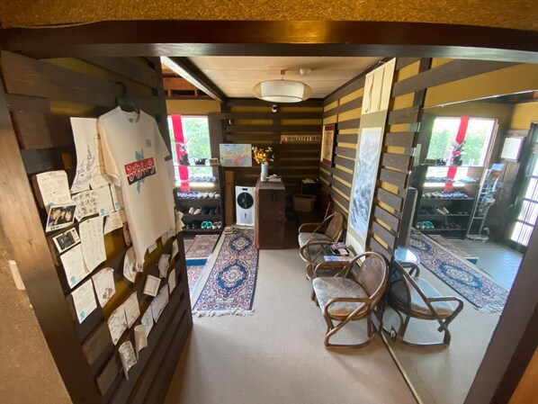 A cozy room with a wooden floor, a patterned rug, and a small desk with a chair.