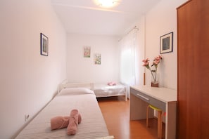 A small, well-lit room with two beds, a desk, and a cabinet. - Apartment 1346/12667 (Istria - Pula), 1000m from the beach (Pula)
