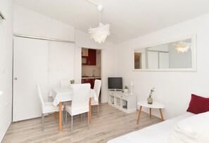 Enjoy a stylish space with a dining area, console table, and comfortable bed.
