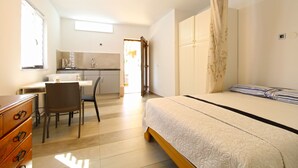 A bedroom with a bed, a desk, and a chair. There is a window and a door leading to the kitchen. - Apartment 1371/12911 (Istria - Pjescana Uvala), 100m from the beach (Pjescana Uvala)