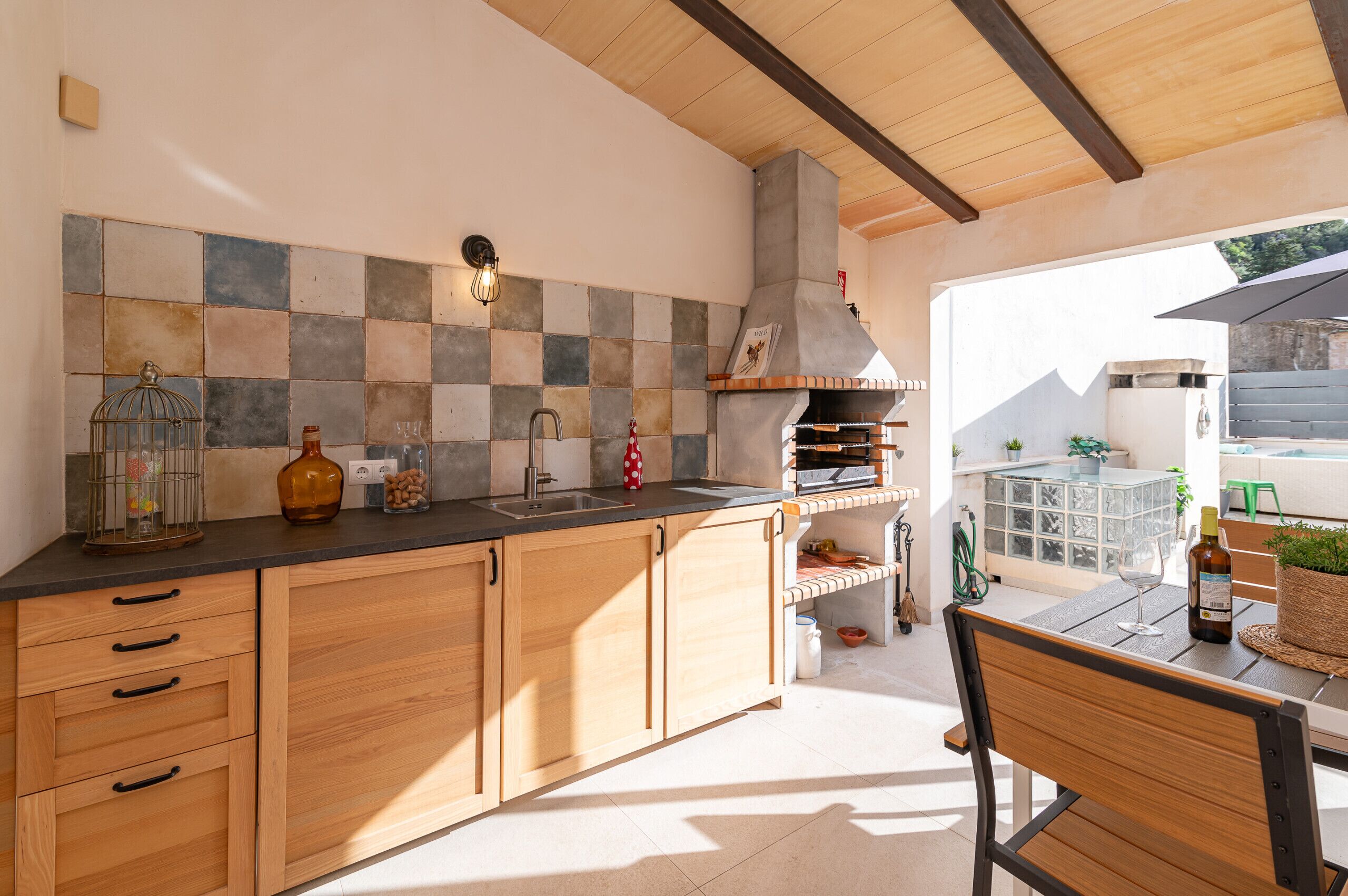 A kitchen with wooden cabinets, a tiled backsplash, and a built-in oven.