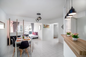 Enjoy a city view from the large window, with a dining area and comfortable seating for relaxation.