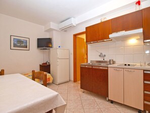 Enjoy cooking in this well-lit kitchen with a microwave and refrigerator.