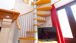 A spiral staircase with a wooden finish and a television on a stand below it. - Apartment 1482/13875 (Istria - Medulin), 600m from the beach (Medulin)