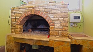 A stone-built fireplace with a brick arch, a firebox, and a chimney. - Apartment 1496/14455 (Istria - Pula), 2500m from the beach (Pula)