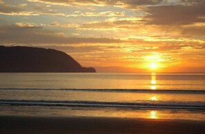 Enjoy a serene beach experience with a wide, open shoreline and breathtaking views of the surrounding landscape.