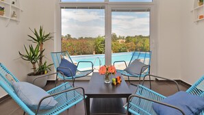 A balcony with a pool view, wicker chairs, and a table with flowers. - Villa 1519/15239 (Istria - Žminj), 25000m from the beach (Žminj)