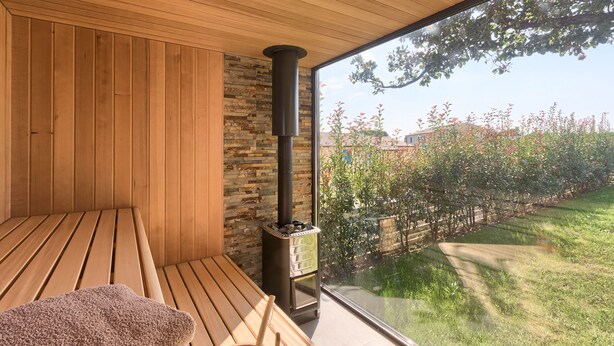 A wooden room with a large window, a stone wall, and a wood-burning stove. - Villa 1521/15241 (Istria - Žminj), 25000m from the beach (Žminj)
